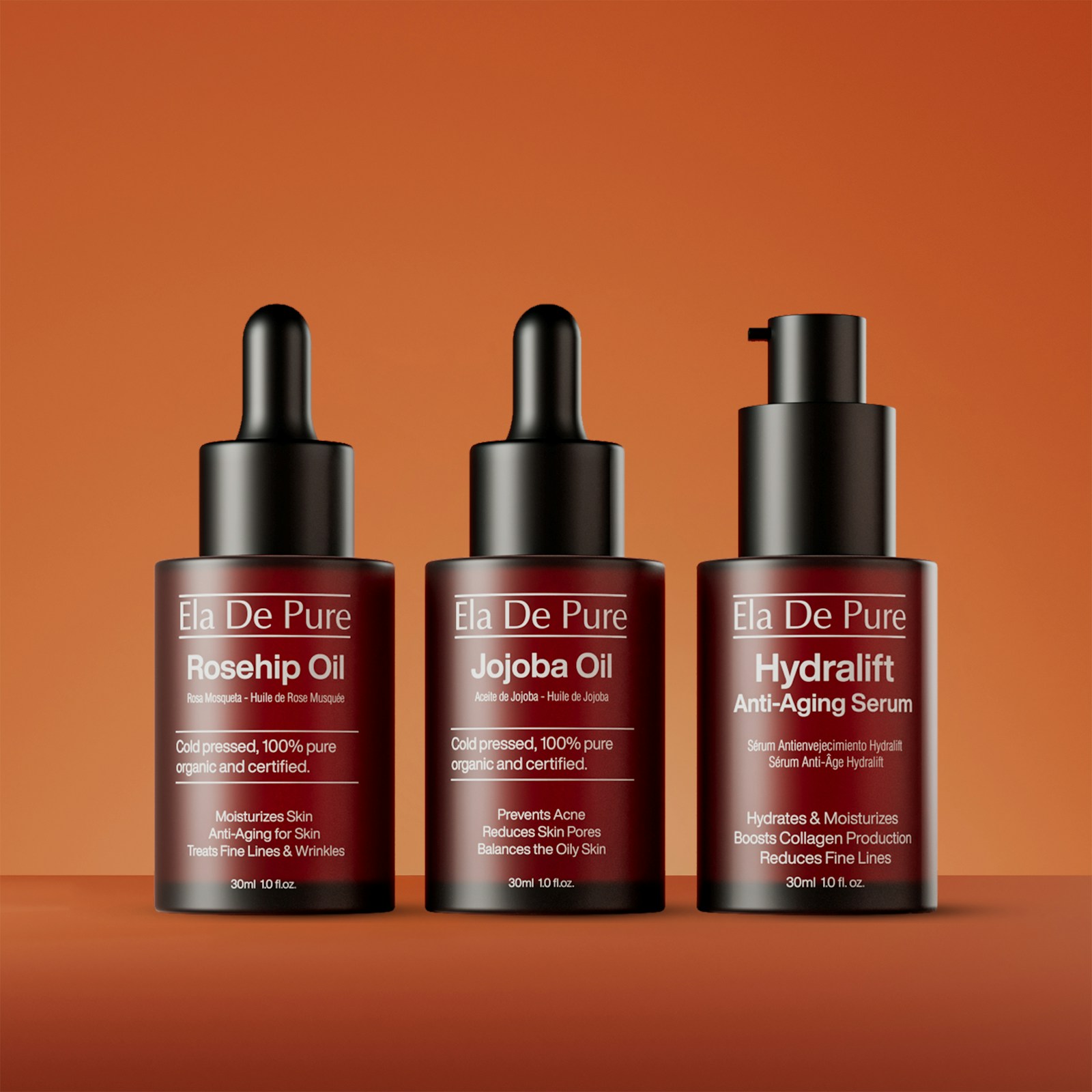 Tre flaconi contagocce di sieri viso su sfondo arancione, idee regalo skincare